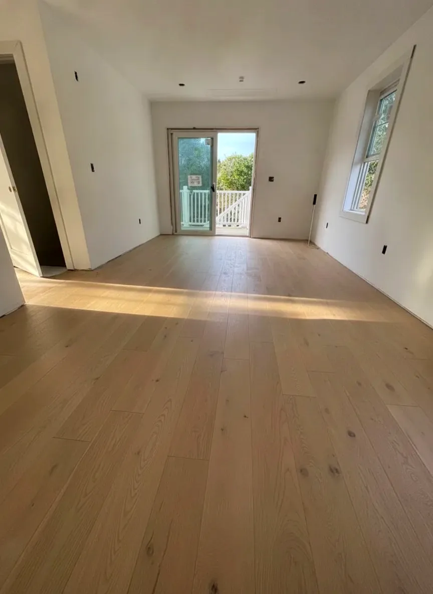 Finished white oak hardwood floor in a bright South Shore room with patio doors