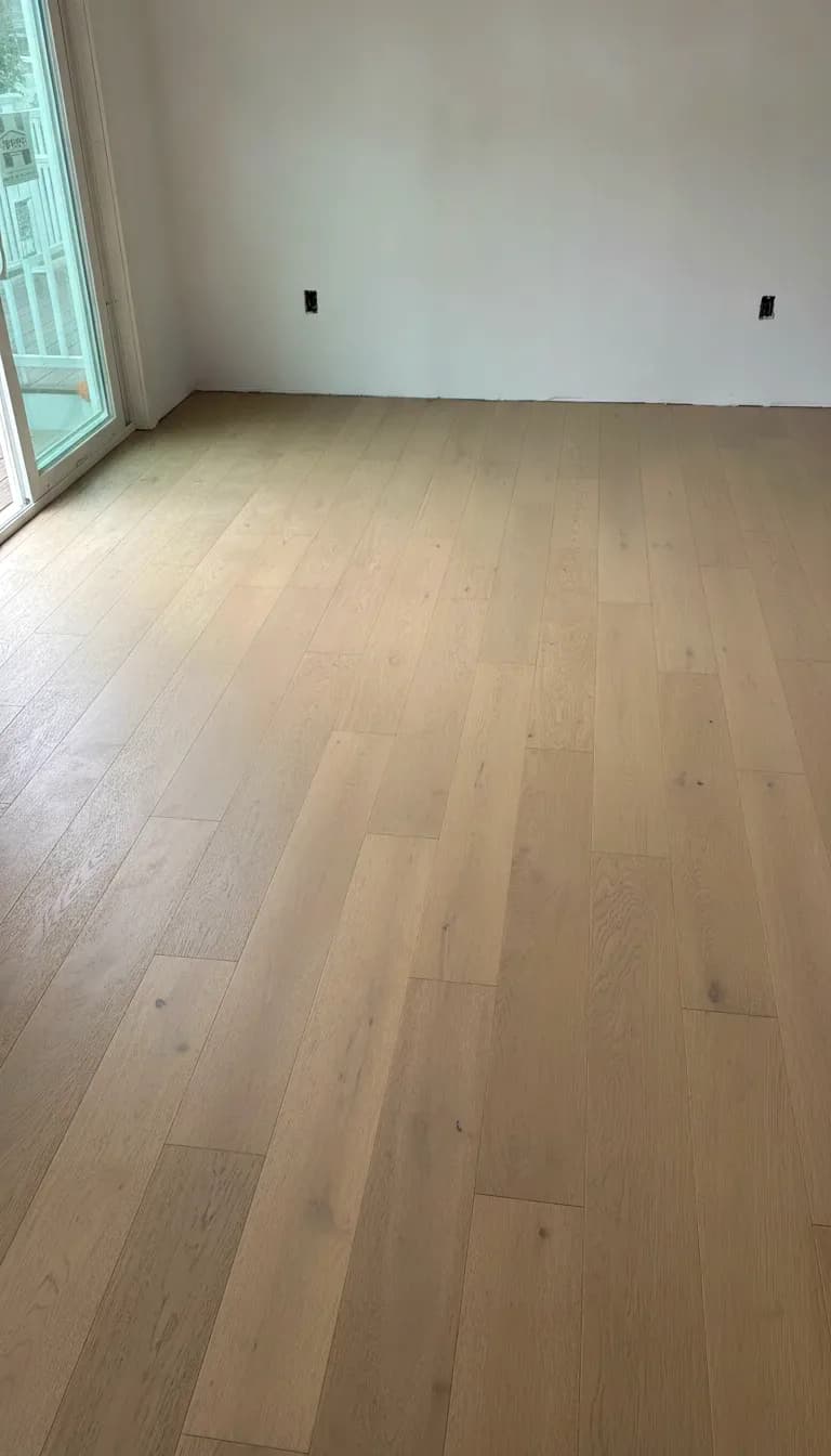 Wall to wall finished white oak hardwood floor in a light-filled room