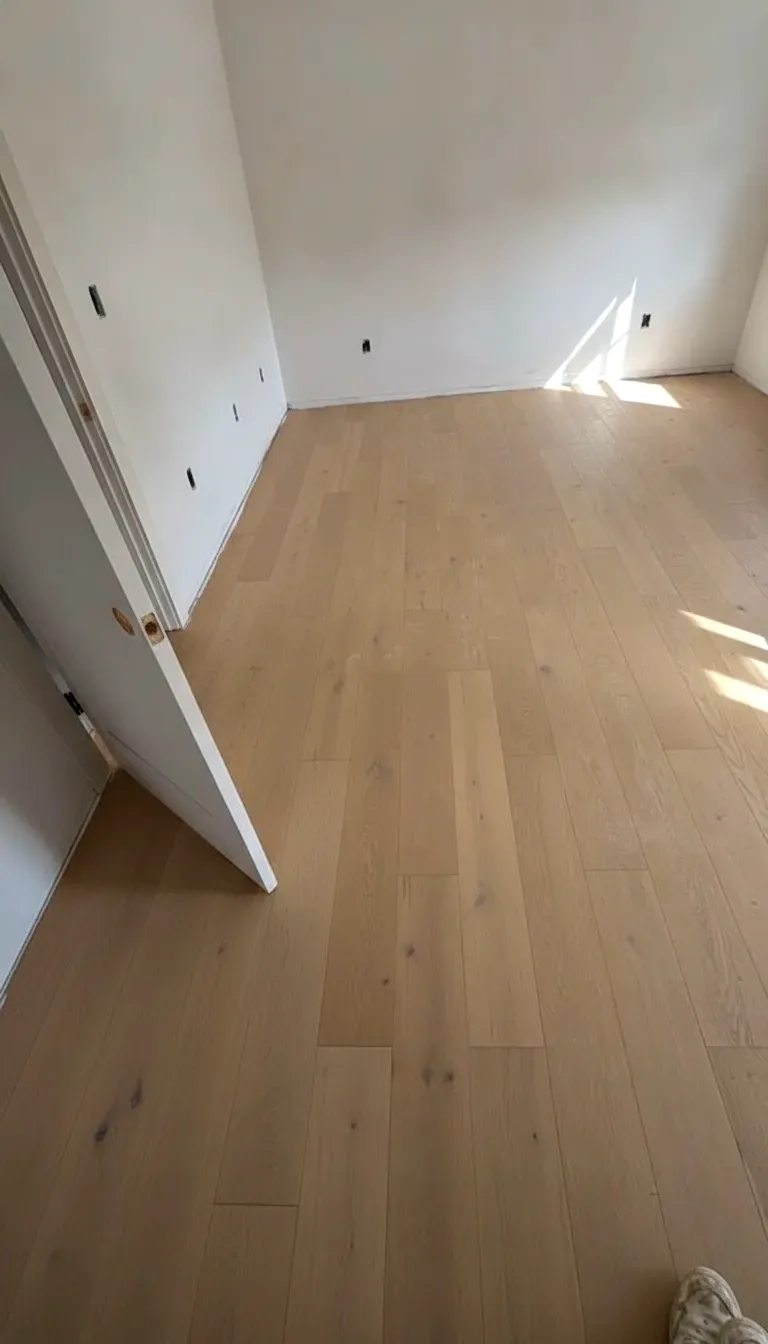 Finished white oak hardwood floor running the length of a room