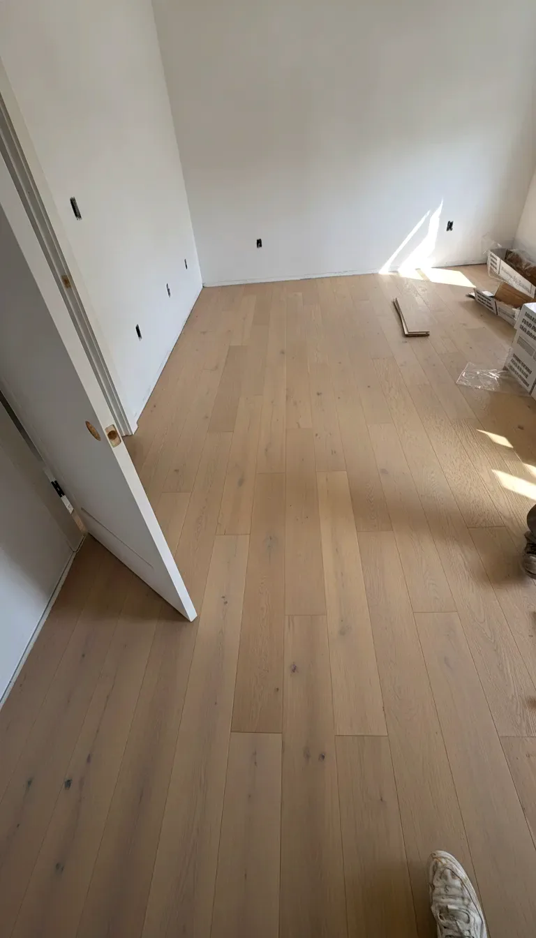 Finished white oak hardwood floor in a bright open room